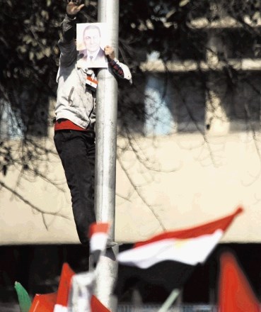 Med poskusi, da  bi zavzeli trg  Tahrir, so  Mubarakovi  podporniki nosili  s seboj njegove  podobe.