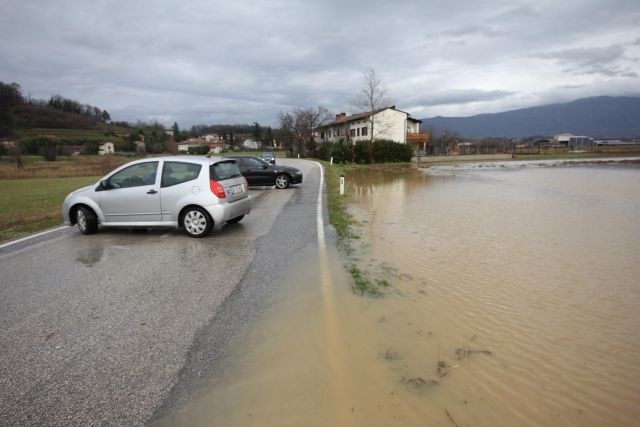 Reka Vipava poplavlja v spodnjem delu doline (na sliki poplavljene ceste in polja pri Bukovici). 