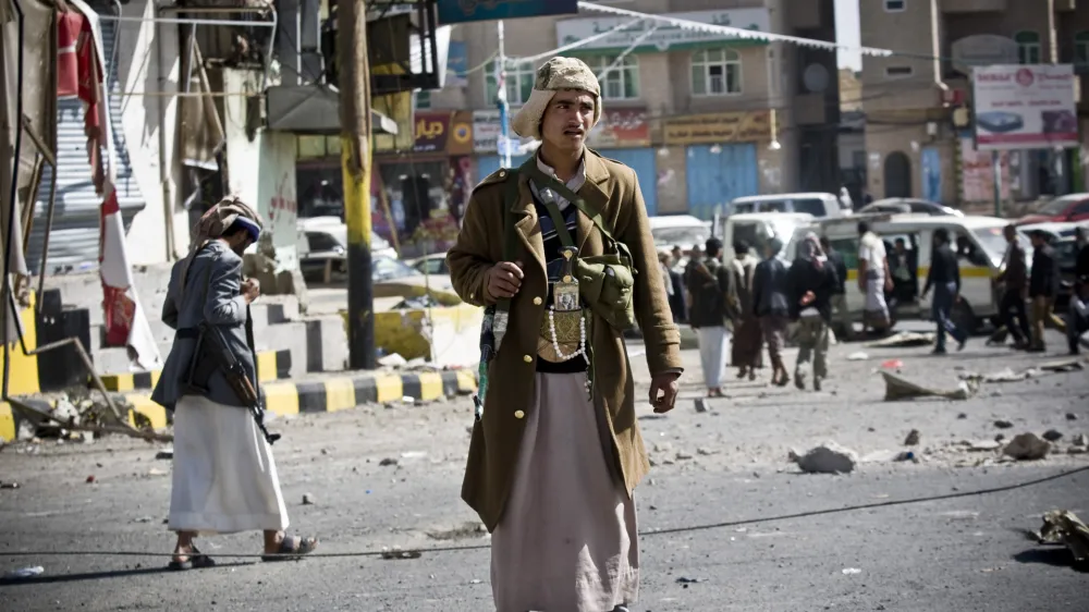FILE - In this Tuesday, Jan. 20, 2015 file photo, Houthi Shiite Yemenis gather while guarding a street leading to the presidential palace in Sanaa, Yemen. The Shiite rebels, known as Houthis, captured the airport and city of Taiz -- a gateway to the south -- and have vowed to press on to Aden, the countrys economic hub, where President Abed Rabbo Mansour Hadi, a close U.S. ally, has taken refuge. (AP Photo/Hani Mohammed, File)