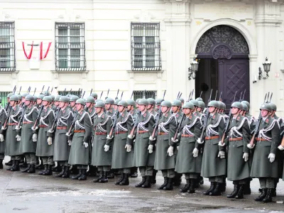 FILE - In this Jan. 15, 2013 file photo Austrian army soldiers stand in front of the chancellery in Vienna, Austria. Austrians eligible to vote are called to participate an army referendum, Sunday, Jan. 20, 2013. At issue in this neutral nation of just over 8 million people is whether to keep the present system that relies heavily on conscripts or to go with the European flow and create a professional army, as have 21 of the EU's 26 other members. The present model consists of about 35,000 troops, with about 14,000 professionals and the rest conscripts who serve for six months as well as a 30,000-strong part-time militia. (AP Photo/dapd, Hans Punz)