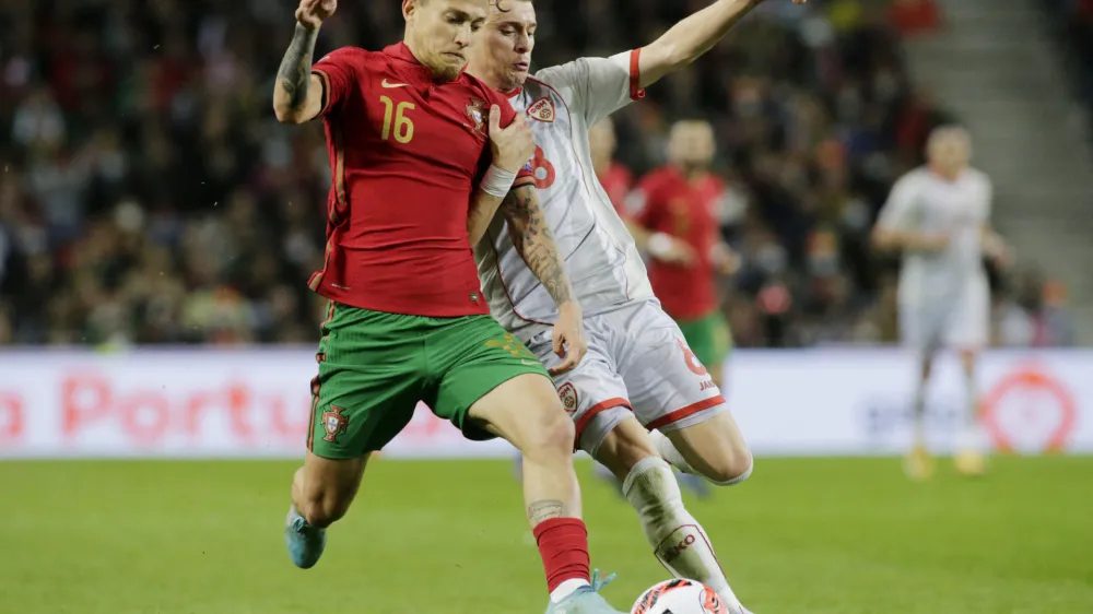 Soccer Football - World Cup - UEFA Qualifiers - Path C Playoff Final - Portugal v North Macedonia - Estadio do Dragao, Porto, Portugal - March 29, 2022 Portugal's Otavio in action with North Macedonia's Ezgjan Alioski REUTERS/Miguel Vidal