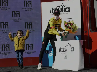 Slovenia's Primoz Roglic and his son celebrate the first stage of the Basque Country La Vuelta cycling race, an individual time trial Hondarribia-Hondarribia, 7,5 km (4,6 miles), in Hondarribia, northern Spain, Monday, April 4, 2022. (AP Photo/Alvaro Barrientos)
