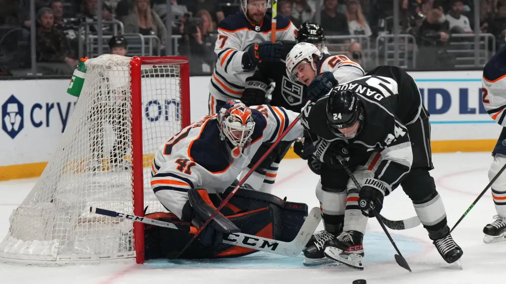 Apr 7, 2022; Los Angeles, California, USA; Edmonton Oilers goaltender Mike Smith (41) and right wing Kailer Yamamoto (56) defend the goal against LA Kings center Phillip Danault (24) in the second period at Crypto.com Arena. Mandatory Credit: Kirby Lee-USA TODAY Sports
