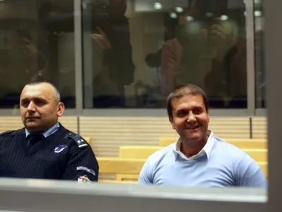 Alleged Balkan drugs boss Darko Saric, who surrendered to Serbian police last week after almost five years on the run, smiles inside a court in Belgrade March 24, 2014. Saric, 43, one of the most wanted figures in the crime-riddled Balkan region, faces 13 indictments including the trafficking of 5.7 tonnes of cocaine from Latin America and the laundering of 22 million euros in Serbia. He denied on Monday any involvement in trafficking cocaine from Latin America to Europe and told his first court hearing that the charges against him had been fabricated. REUTERS/Djordje Kojadinovic (SERBIA - Tags: CRIME LAW DRUGS SOCIETY) - GM1EA3O1SKA01