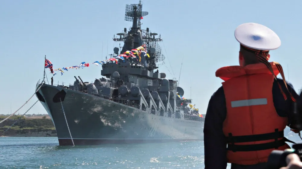 FILE PHOTO: FILE PHOTO: A sailor looks at the Russian missile cruiser Moskva moored in the Ukrainian Black Sea port of Sevastopol, Ukraine 10, 2013. REUTERS/Stringer/File Photo/File Photo