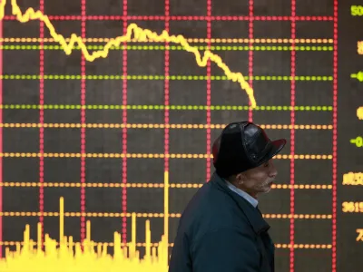 An investor stands in front of an electronic board showing stock information at a brokerage house in Huaibei, Anhui province January 11, 2013. China shares posted their worst daily loss in nearly four months on Friday, snapping a five-week winning streak after higher-than-expected December inflation crimped expectations for further monetary easing. REUTERS/Stringer (CHINA - Tags: BUSINESS TPX IMAGES OF THE DAY) CHINA OUT. NO COMMERCIAL OR EDITORIAL SALES IN CHINA