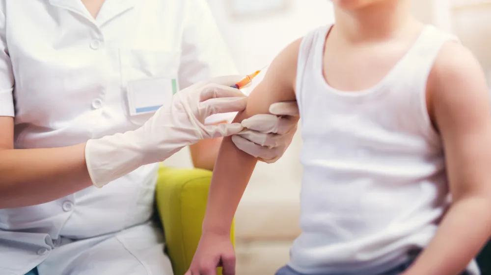 Pediatrician makes vaccination to small boy