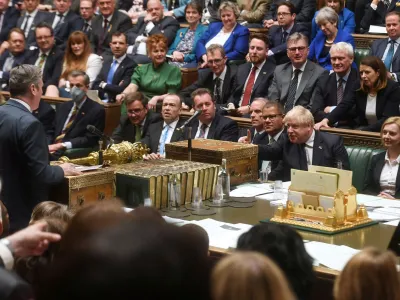 FILE PHOTO: British Prime Minister Boris Johnson gestures as Labour Party opposition leader Keir Starmer speaks during Prime Minister's Questions at the House of Commons in London, Britain April 20, 2022. UK Parliament/Jessica Taylor/Handout via REUTERS THIS IMAGE HAS BEEN SUPPLIED BY A THIRD PARTY. MANDATORY CREDIT. IMAGE MUST NOT BE ALTERED./File Photo