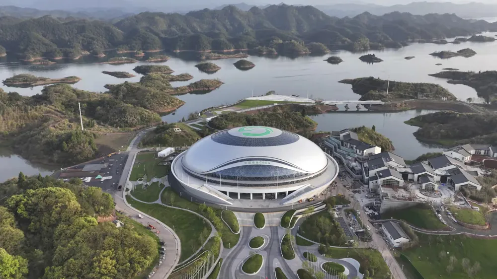 In this photo released by Xinhua News Agency, an aerial photo taken on March 28, 2022, shows a view of Chun'an Jieshou Sports Centre Velodrome, a venue of the 19th Asian Games Hangzhou 2022 in Hangzhou, eastern China's Zhejiang Province. Less than three months after Beijing hosted the Winter Olympics and Paralympics, the Olympic Council of Asia said Friday that this year's Asian Games in China are being postponed because of concerns about the spreading omicron variant of COVID-19 in the country.(Zhou Hengzhong/Xinhua via AP)