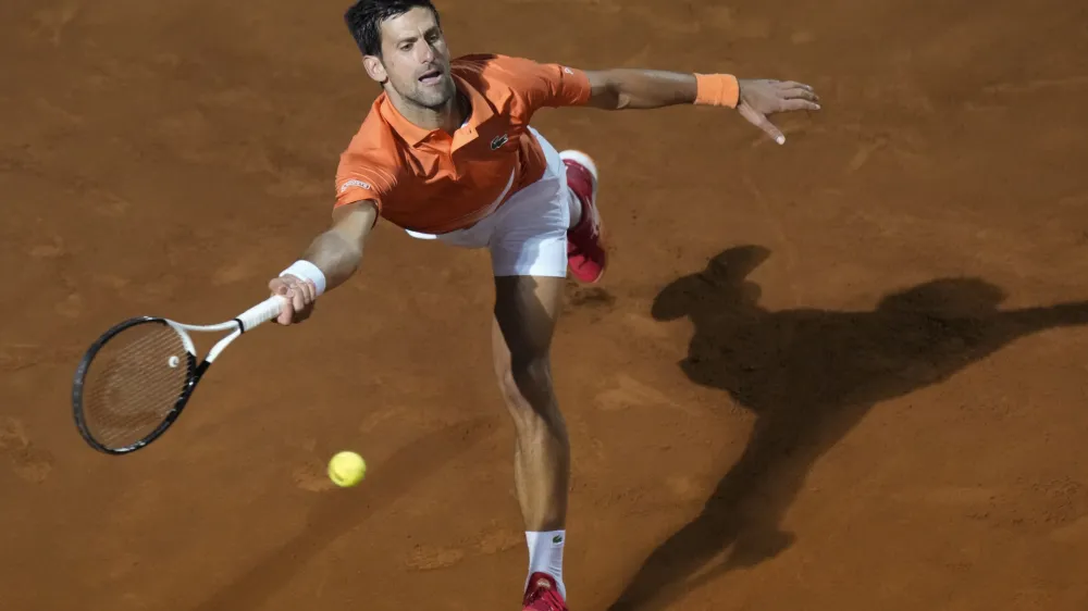 Novak Djokovic of Serbia returns the ball to Felix Auger-Aliassime of Canada during their match at the Italian Open tennis tournament, in Rome, Friday, May 13, 2022. (AP Photo/Andrew Medichini)
