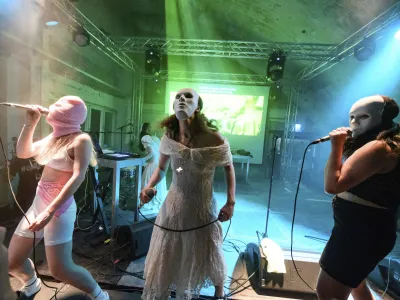 Diana Burkot, from left, Maria Alyokhina and Olga Borisova perform at the concert of the anti-Kremlin and feminist band Pussy Riot held at Funkhaus Berlin, in Berlin, Germany, Thursday, May 12, 2022. The 33-year-old Alyokhina had only recently fled Russia. Based on the book "Riot Days" by Alyokhina, the "Pussy Riot Anti-War Tour" presented a performance project consisting of music, theater and video recordings. (Bernd von Jutrczenka/dpa via AP)