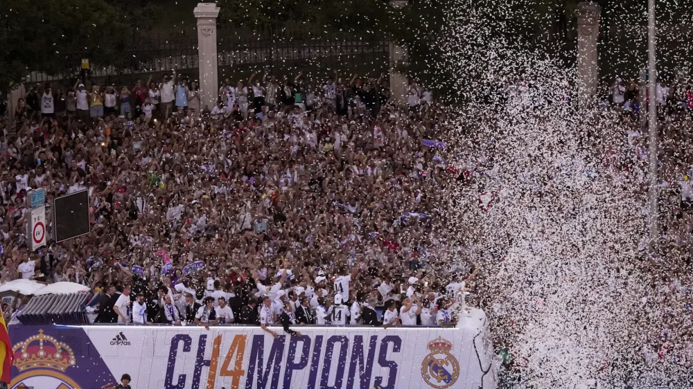 Real Madrid players on an open-top bus during the trophy parade in front of the City Hall in Madrid, Spain, Sunday, May 29, 2022. Real Madrid beat Liverpool 1-0 in the Champions League final in Paris. (AP Photo/Manu Fernandez)