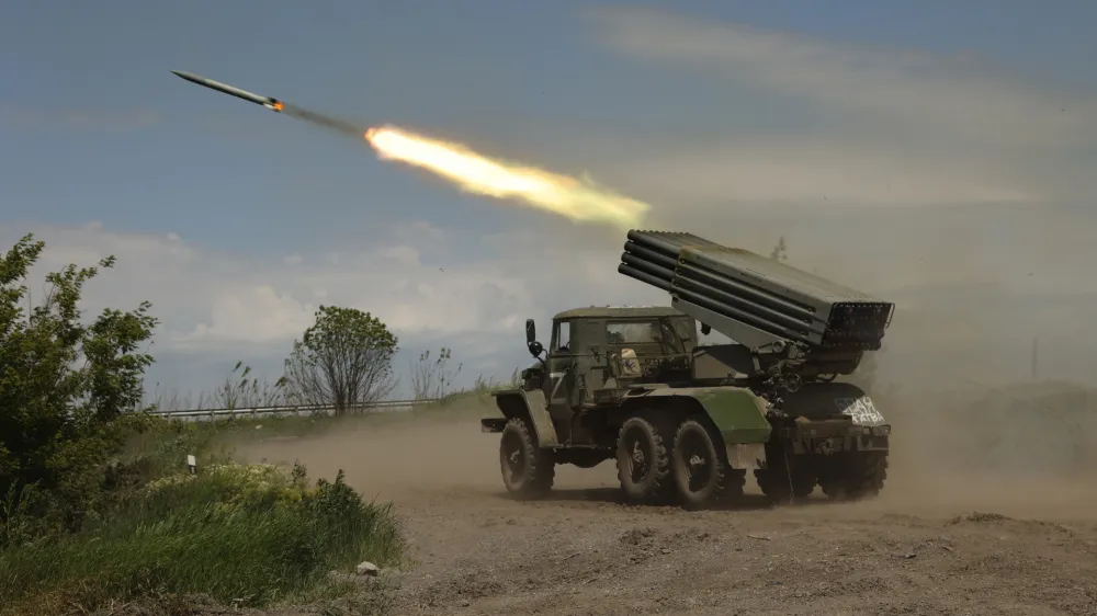A Donetsk People's Republic militia's multiple rocket launcher fires from its position not far from Panteleimonivka, in territory under the government of the Donetsk People's Republic, eastern Ukraine, Saturday, May 28, 2022. (AP Photo/Alexei Alexandrov)