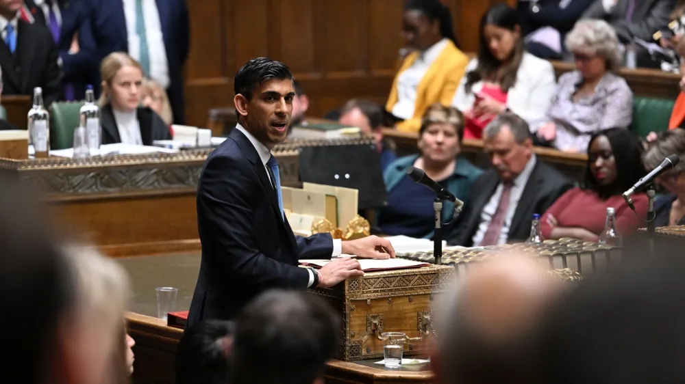 In this photo provided by UK Parliament, Britain's Chancellor Rishi Sunak makes a statement in the House of Commons, London, Thursday, May 26, 2022. Britain's Conservative government has unveiled a $19 billion package to ease a severe cost-of-living squeeze. Treasury chief Rishi Sunak said Thursday that the government would introduce a temporary windfall tax on the profits of oil and gas firms. (Jessica Taylor/UK Parliament via AP)