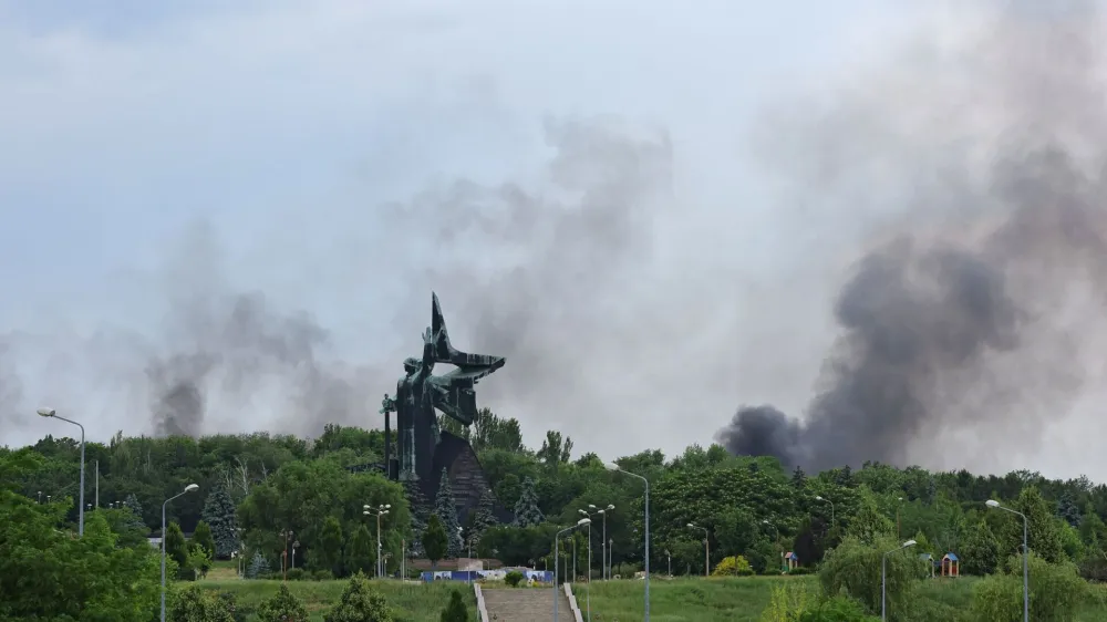 Smoke rises near the World War Two monument following recent shelling during Ukraine-Russia conflict in Donetsk, Ukraine June 18, 2022. REUTERS/Alexander Ermochenko