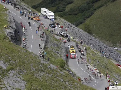The pack climbs Galibier pass during the 19th stage of the Tour de France cycling race over 109.5 kilometers (86 miles) starting in Modane Valfrejus and finishing on Alpe d'Huez, Alps region, France, Friday July 22, 2011. (AP Photo/Christophe Ena)