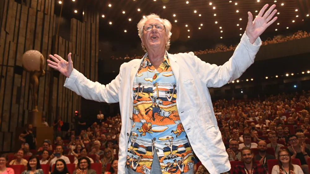 Australian actor Geoffrey Rush gestures on a stage in front of the audience&nbsp;prior to a screening of The King's Speech movie at the 56th Karlovy Vary International Film Festival in Karlovy Vary, Czech Republic, Wednesday, July 6, 2022. (Slavomir Kubes/CTK via AP)