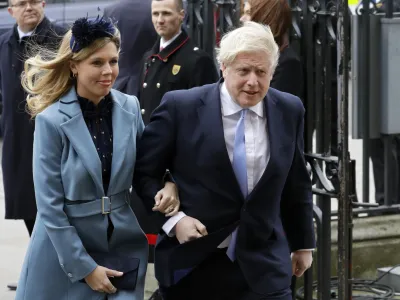 FILE - In this Monday, March 9, 2020 file photo Britain's Prime Minister Boris Johnson and his partner Carrie Symonds arrive to attend the annual Commonwealth Day service at Westminster Abbey in London. Boris Johnson and his partner Carrie Symonds have announced she gave birth to a "healthy baby boy at a London hospital earlier this morning" Wednesday April 29, 2020, and both mother and baby are doing well. (AP Photo/Kirsty Wigglesworth, File)