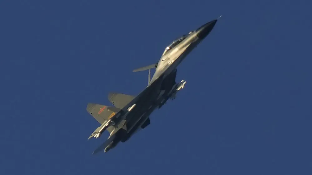 A Chinese J-11 military fighter jet flies above the Taiwan Strait near Pingtan, the closest land of mainland China to the island of Taiwan, in Pingtan in southeastern China's Fujian Province, Friday, Aug. 5, 2022. China says it is canceling or suspending dialogue with the U.S. on issues from climate change to military relations and anti-drug efforts in retaliation for a visit this week to Taiwan by U.S. House Speaker Nancy Pelosi. (AP Photo/Ng Han Guan)