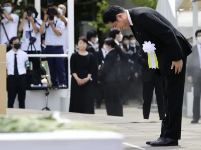 Japanese Prime Minister Fumio Kishida bows during a ceremony to mark the 77th anniversary of the atomic bombing in Nagasaki, southern Japan, Tuesday, Aug. 9, 2022. (Kyodo News via AP)