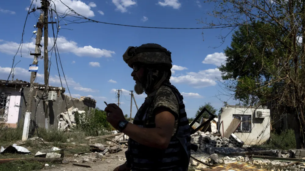 A Ukrainian serviceman walks on a street at the frontline in Mykolaiv region, Ukraine, on Monday, Aug. 8, 2022. (AP Photo/Evgeniy Maloletka)