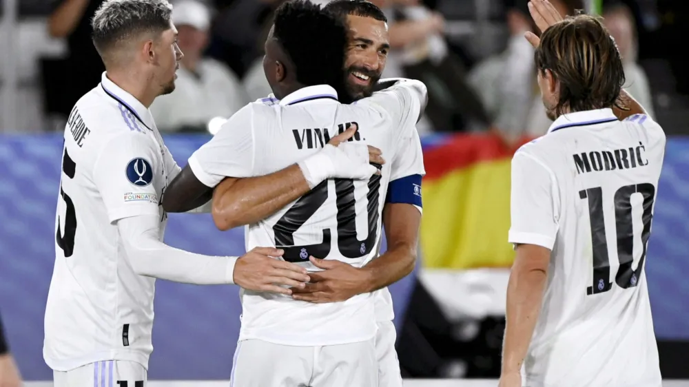 Soccer Football - European Super Cup - Real Madrid v Eintracht Frankfurt - Helsinki Olympic Stadium, Helsinki, Finland - August 10, 2022 Real Madrid's Karim Benzema celebrates scoring their second goal with Federico Valverde, Vinicius Junior and Luka Modric Emmi Korhonen/Lehtikuva via REUTERS ATTENTION EDITORS - THIS IMAGE WAS PROVIDED BY A THIRD PARTY. NO THIRD PARTY SALES. NOT FOR USE BY REUTERS THIRD PARTY DISTRIBUTORS. FINLAND OUT. NO COMMERCIAL OR EDITORIAL SALES IN FINLAND.