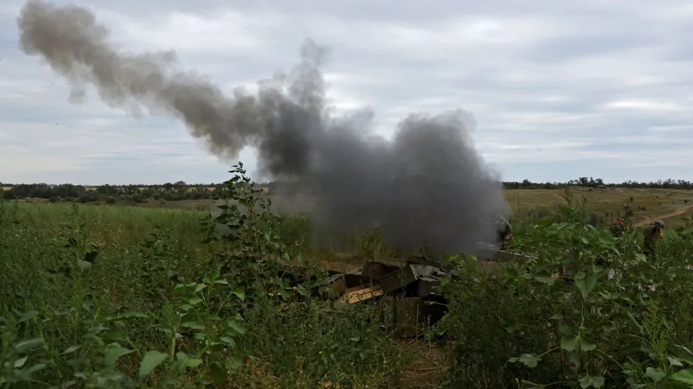 Service members of the self-proclaimed Luhansk People's Republic fire a 2A65 Msta-B howitzer in the direction of Soledar during Ukraine-Russia conflict in the Luhansk Region, Ukraine August 13, 2022. REUTERS/Alexander Ermochenko