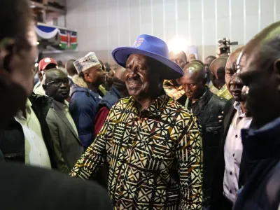 Kenyan presidential candidate Raila Odinga, center, walks through the crowd during departure after delivering an address to the nation at his campaign headquarters in downtown Nairobi, Kenya, Tuesday, Aug. 16, 2022. Kenya is calm a day after Deputy President William Ruto was declared the winner of the narrow presidential election over longtime opposition figure Raila Odinga. (AP Photo/Ben Curtis)