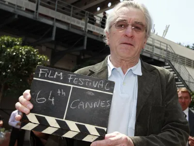 Actor Robert De Niro, president of the jury of the 64th Cannes Film Festival, holds a film clapper in Cannes May 11, 2011. The film festival runs from May 11 to 22.    REUTERS/Eric Gaillard (FRANCE - Tags: ENTERTAINMENT)