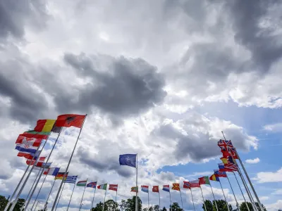 Flags of NATO member countries flap in the wind outside NATO headquarters prior to NATO Secretary General Jens Stoltenberg and the Chair of the Presidency of Bosnia and Herzegovina Sefik Dzaferovic speech at a media conference in Brussels, Wednesday, May 27, 2022. (AP Photo/Olivier Matthys)