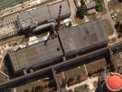 This satellite image provided by Maxar Technologies shows recent damage to the roof of a building adjacent to several of the nuclear reactors at the Zaporizhzhia nuclear plant in Russian occupied Ukraine, Monday Aug. 29, 2022. A team from the U.N. nuclear watchdog on Monday started its journey to the Zaporizhzhia atomic power plant at the heart of fighting in Ukraine, a long-awaited mission to inspect crucial safety systems that the world hopes will help avoid a catastrophe. (Satellite image ©2022 Maxar Technologies via AP)
