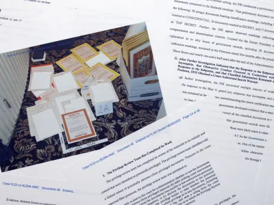 Pages from a Department of Justice court filing on Aug. 30, 2022, in response to a request from the legal team of former President Donald Trump for a special master to review the documents seized during the Aug. 8 search of Mar-a-Lago, are photographed early Wednesday, Aug. 31, 2022. Included in the filing was a FBI photo of documents that were seized during the search. (AP Photo/Jon Elswick)