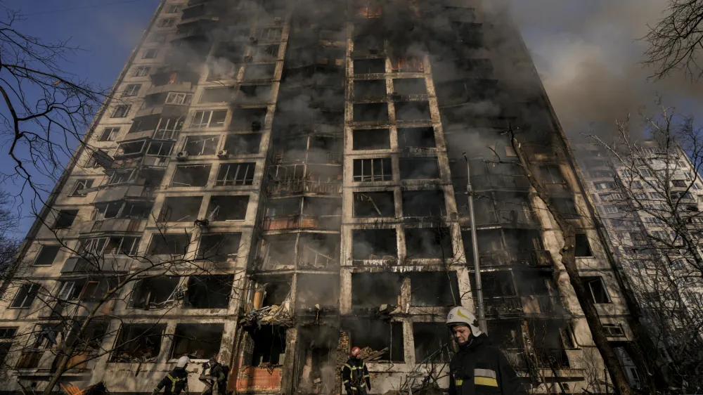 Firefighters work outside a destroyed apartment building after a bombing in a residential area in Kyiv, Ukraine, Tuesday, March 15, 2022. Russia's offensive in Ukraine has edged closer to central Kyiv with a series of strikes hitting a residential neighborhood as the leaders of three European Union member countries planned a visit to Ukraine's embattled capital. (AP Photo/Vadim Ghirda)