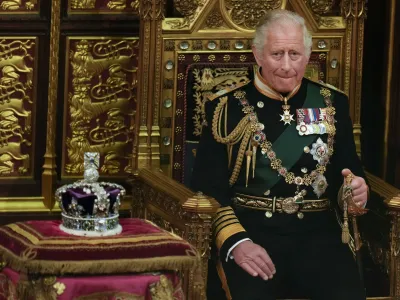 FILE - Prince Charles is seated next to the Queen's crown during the State Opening of Parliament, at the Palace of Westminster in London, May 10, 2022. Queen Elizabeth II did not attend the opening of Parliament amid ongoing mobility issues. Prince Charles has been preparing for the crown his entire life. Now, that moment has finally arrived. Charles, the oldest person to ever assume the British throne, became king on Thursday Sept. 8, 2022, following the death of his mother, Queen Elizabeth II. (AP Photo/Alastair Grant, Pool, File)