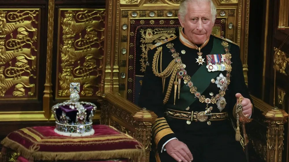 FILE - Prince Charles is seated next to the Queen's crown during the State Opening of Parliament, at the Palace of Westminster in London, May 10, 2022. Queen Elizabeth II did not attend the opening of Parliament amid ongoing mobility issues. Prince Charles has been preparing for the crown his entire life. Now, that moment has finally arrived. Charles, the oldest person to ever assume the British throne, became king on Thursday Sept. 8, 2022, following the death of his mother, Queen Elizabeth II. (AP Photo/Alastair Grant, Pool, File)