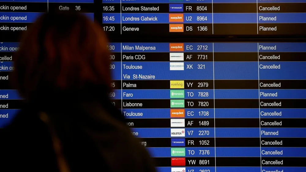 A traveller looks at a flight departure screen displaying a series of flight cancellations during an air traffic controller's strike at the Nantes Atlantique airport in Bouguenais near Nantes, France, September 16, 2022. REUTERS/Stephane Mahe