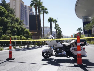 Police tape blocks off a road near where multiple people were stabbed in front of a Strip casino in Las Vegas, Thursday, Oct. 6, 2022. Police say an attacker has killed two people and wounded six others in stabbings along the Las Vegas Strip. (Brian Ramos/Las Vegas Sun via AP)