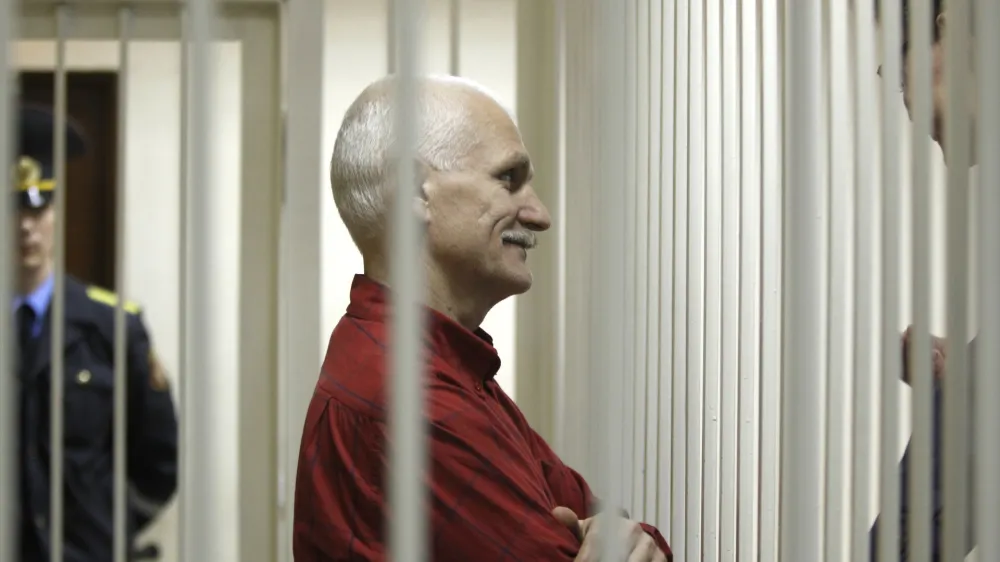 FILE- Ales Belyatsky, the jailed leader of Vesna, the most prominent human rights group in Belarus, stands in a cage during a court session in Minsk, Belarus, Thursday, Nov. 24, 2011. Ales Belyatsky won the Nobel Peace Prize Friday, Oct. 7, 2022. (AP Photo/Sergei Grits, FILE)