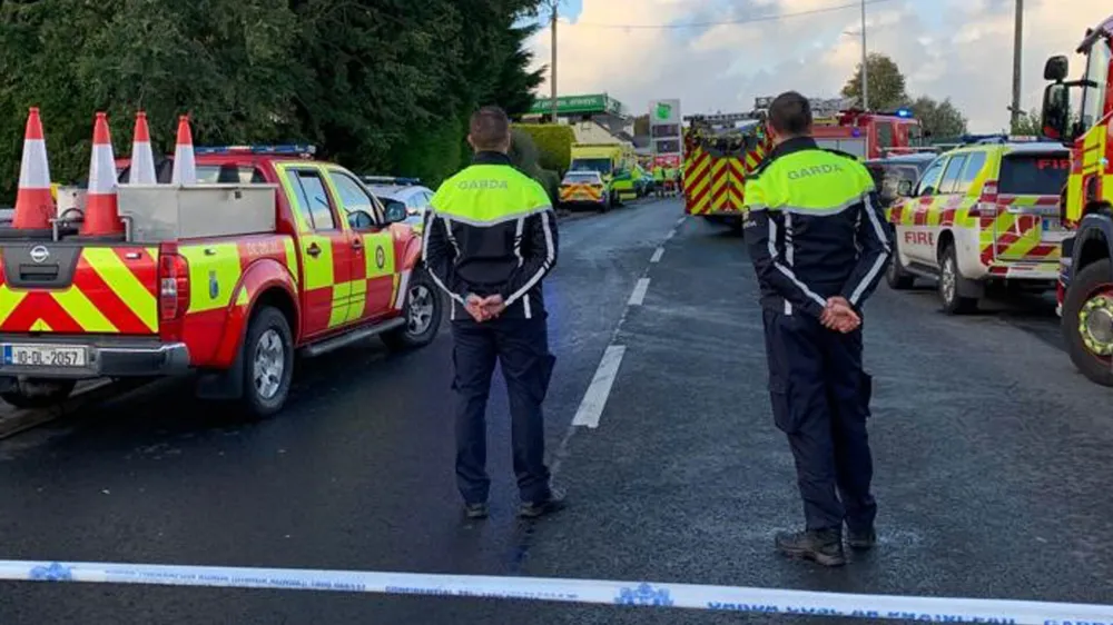 07 October 2022, Ireland, Creeslough: Rescue workers atand at the scene after an explosion at a gas station in County Donegal. Photo: Nina Gabel/PA Wire/dpa