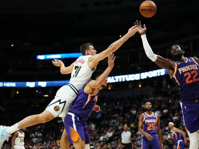 Oct 10, 2022; Denver, Colorado, USA; Phoenix Suns center Deandre Ayton (22) and guard Devin Booker (1) and Denver Nuggets forward Vlatko Cancar (31) reach for the ball in the second half at Ball Arena. Mandatory Credit: Ron Chenoy-USA TODAY Sports