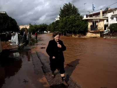 ﻿A local walks next to a flooded street following a heavy rainfall in the town of Mandra, Greece, November 15, 2017. REUTERS/Alkis Konstantinidis
