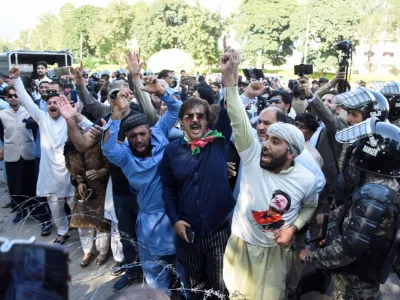 Supporters of the Pakistan Tehreek-e-Insaf (PTI) political party chant slogans, after Pakistan Election Commission disqualifies former Prime Minister Imran Khan on charges of unlawfully selling state gifts, during a protest in Islamabad, Pakistan October 21, 2022. REUTERS/Waseem Khan NO RESALES. NO ARCHIVES.