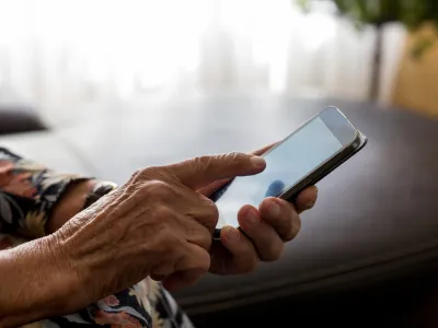 ﻿Old woman hands with mobile phone, closeup shot