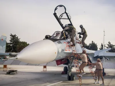 FILE - In this file photo taken on Thursday, Oct. 22, 2015, Russian air force pilots assisted by ground crew climb into their fighter jet at Hemeimeem airbase, Syria. (AP Photo/Vladimir Isachenkov, File)