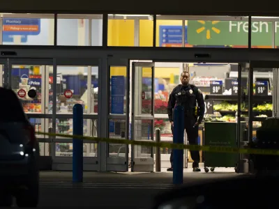 Law enforcement work at the scene of a mass shooting at a Walmart, Wednesday, Nov. 23, 2022, in Chesapeake, Va. (AP Photo/Alex Brandon)