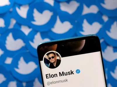 FILE PHOTO: Elon Musk's Twitter profile is seen on a smartphone placed on printed Twitter logos in this picture illustration taken April 28, 2022. REUTERS/Dado Ruvic/Illustration/File Photo/File Photo