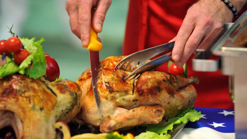 A chef cuts slices of a turkey during a presentation of traditional Thanksgiving dishes, in Macedonia's capital Skopje, on Wednesday, Nov. 4, 2009. The food presentation was organized by USA Poultry & Egg Export Council, a non-profit, industry-sponsored trade organization dedicated to increasing exports of United States poultry and egg food products. The food was prepared by Macedonian chefs by instructions of the U.S. culinary consultant and Chef David Bonom. (AP Photo/Boris Grdanoski)