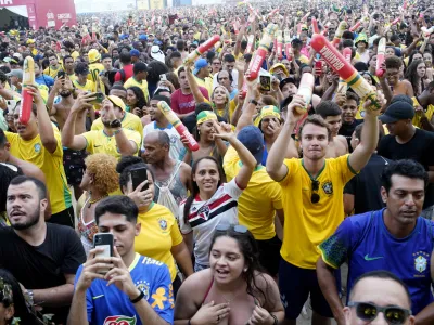 Fans celebrate after Brazil won its round of 16 World Cup soccer match against South Korea, at the FIFA Fan Festival Arena on Copacabana beach in Rio de Janeiro, Brazil, Monday, Dec. 5, 2022. (AP Photo/Ricardo Borges)