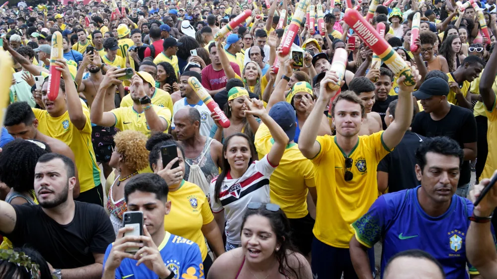Fans celebrate after Brazil won its round of 16 World Cup soccer match against South Korea, at the FIFA Fan Festival Arena on Copacabana beach in Rio de Janeiro, Brazil, Monday, Dec. 5, 2022. (AP Photo/Ricardo Borges)
