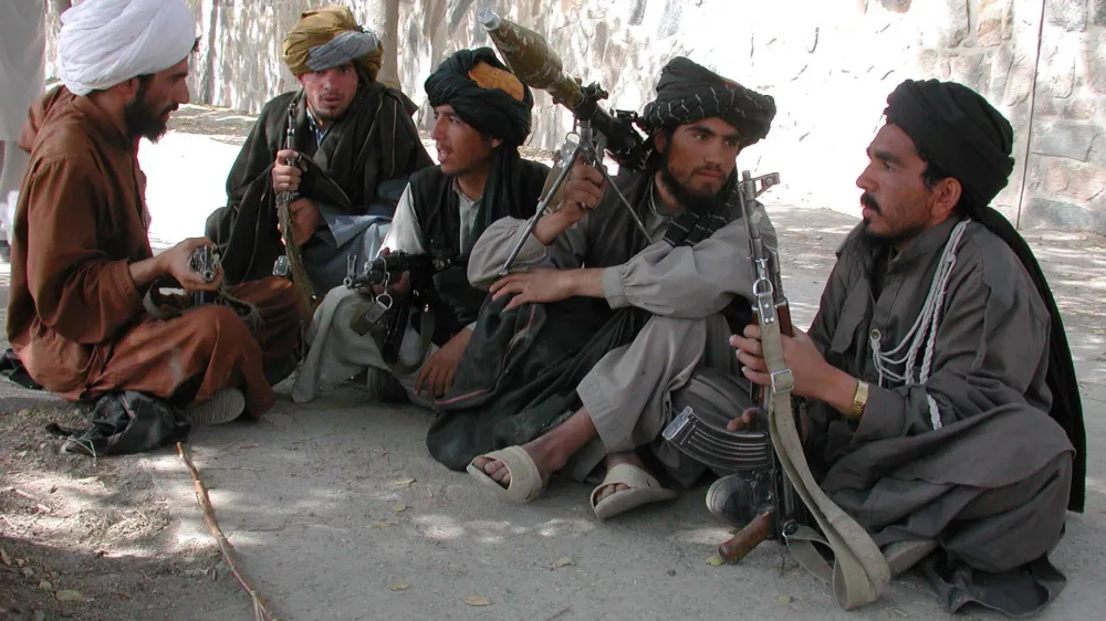 Talibans fighters sit outside the American embassy before it was raided<br>by thousands of angry demonstrators in Kabul on September 26, 2001.<br>Demonstrators set fire to part of the embassy compound in protest<br>agaainst Washington's threat to attack the ruling Taliban for its<br>continued harbouring of Saudi dissident, Osama bin Laden REUTERS/Sayed<br>Salahuddin<br><br>SS/CRB